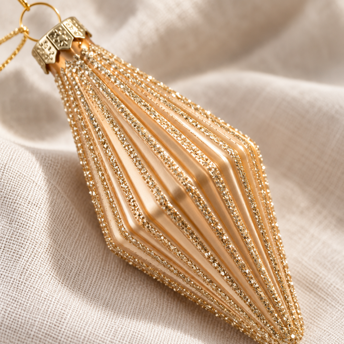 Champagne gold mini finial bauble showing its ribbed finish and glitter detail