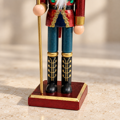 Detail of the nutcracker's blue trousers, black and gold boots and red wooden base