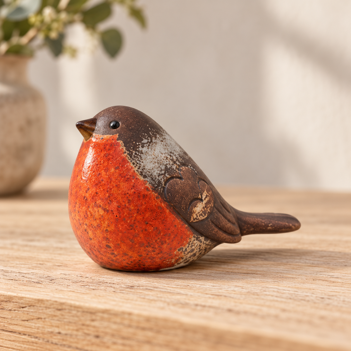 Side profile of a traditional matte ceramic robin showing its brown wing and tail