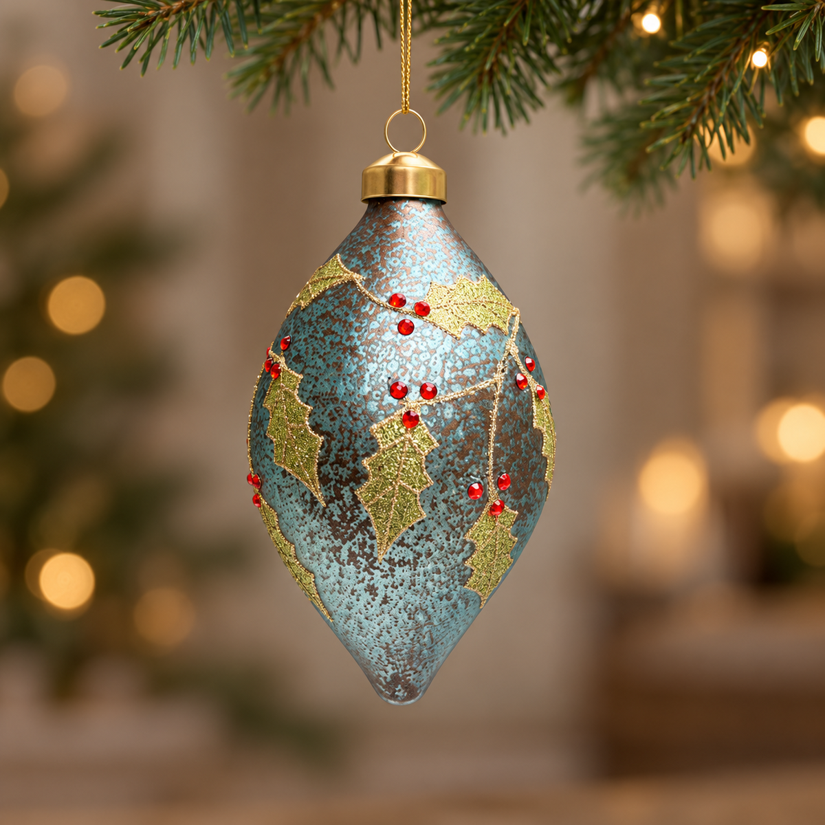 Front view of the handmade blue glass finial bauble with glittered holly and red berries