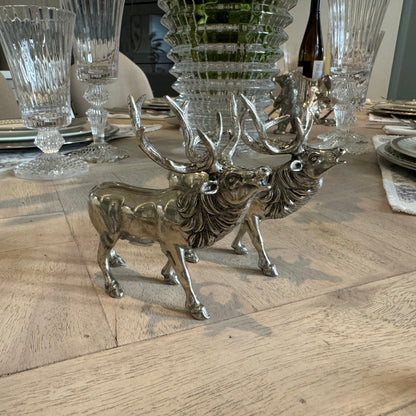 Pewter roaring stag salt and pepper shakers with raised heads on a dining table