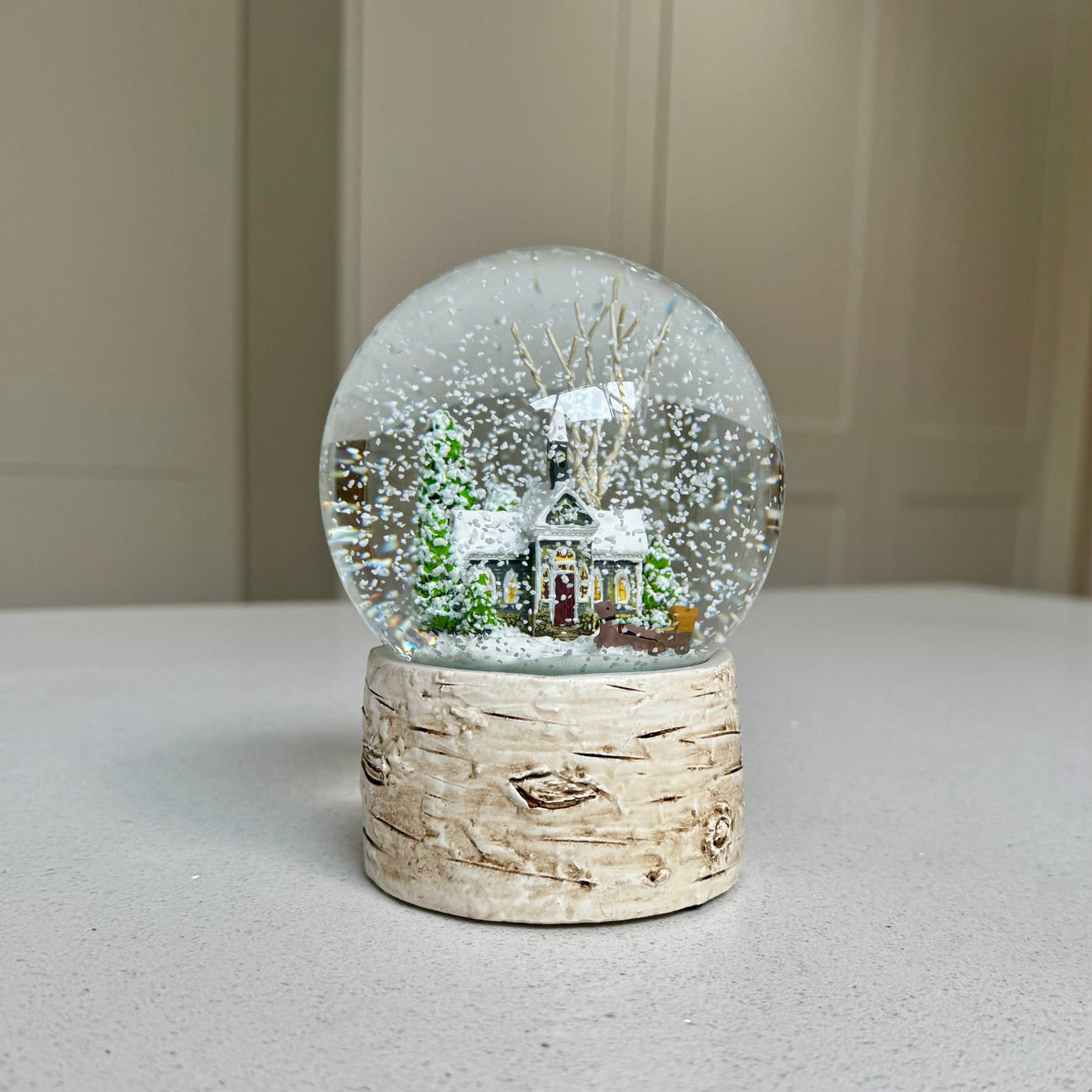 Colourful snowy winter house Christmas snow globe