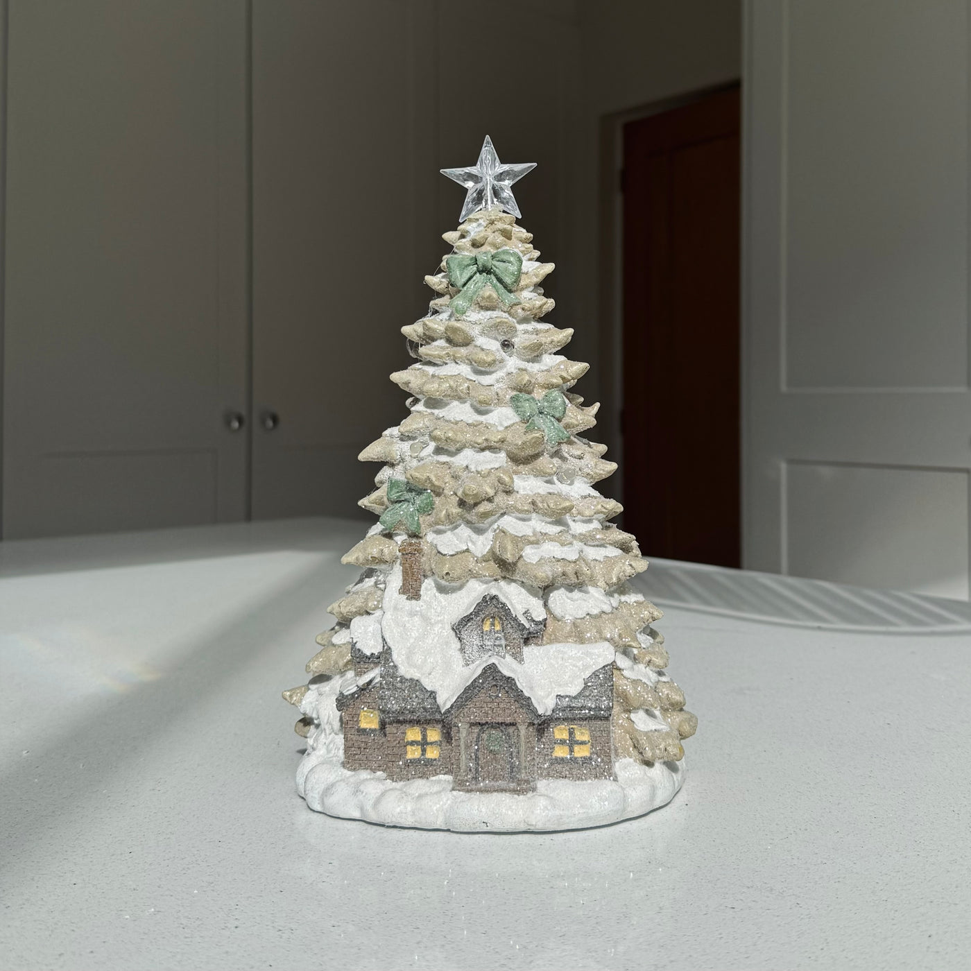 Snowy light-up Christmas house and tree decoration