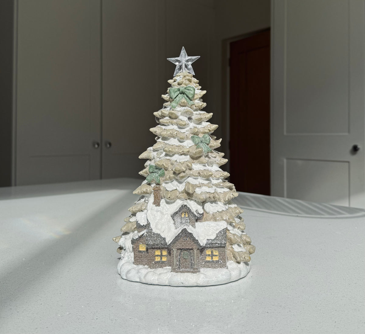 Snowy light-up Christmas house and tree decoration
