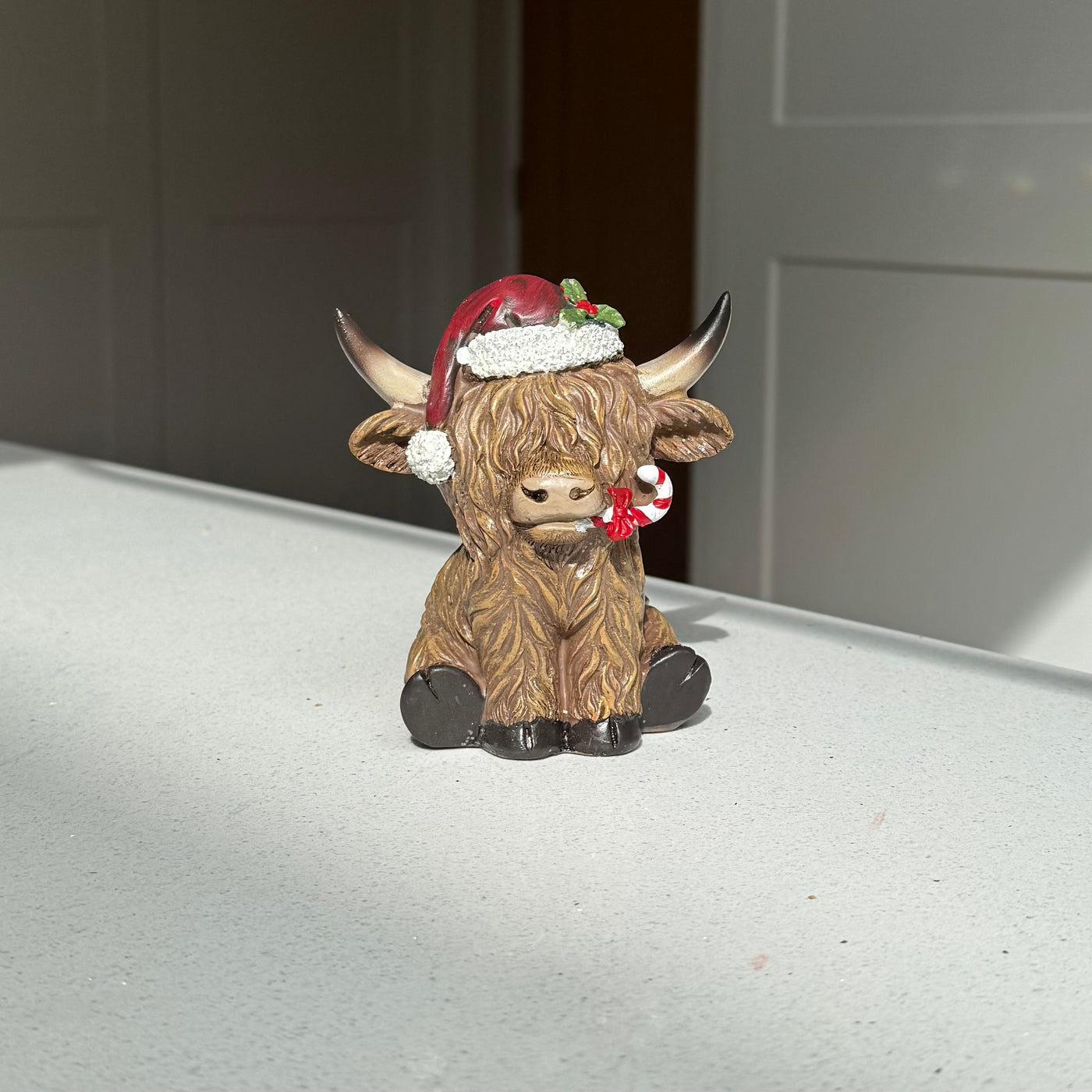 Festive Highland Cow Ornament with Candy Cane – 11cm