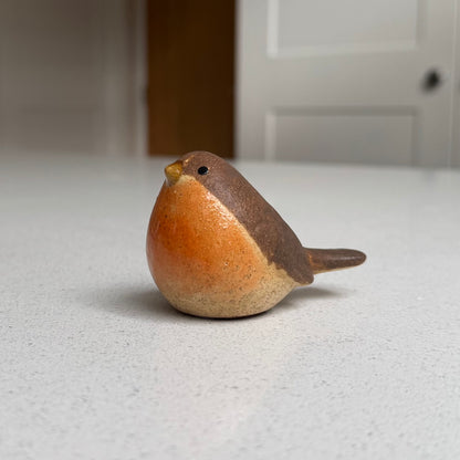 Small resting orange-breasted ceramic robin