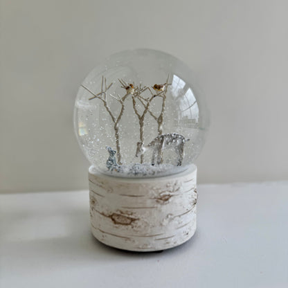 Musical snow globe playing We Wish You a Merry Christmas