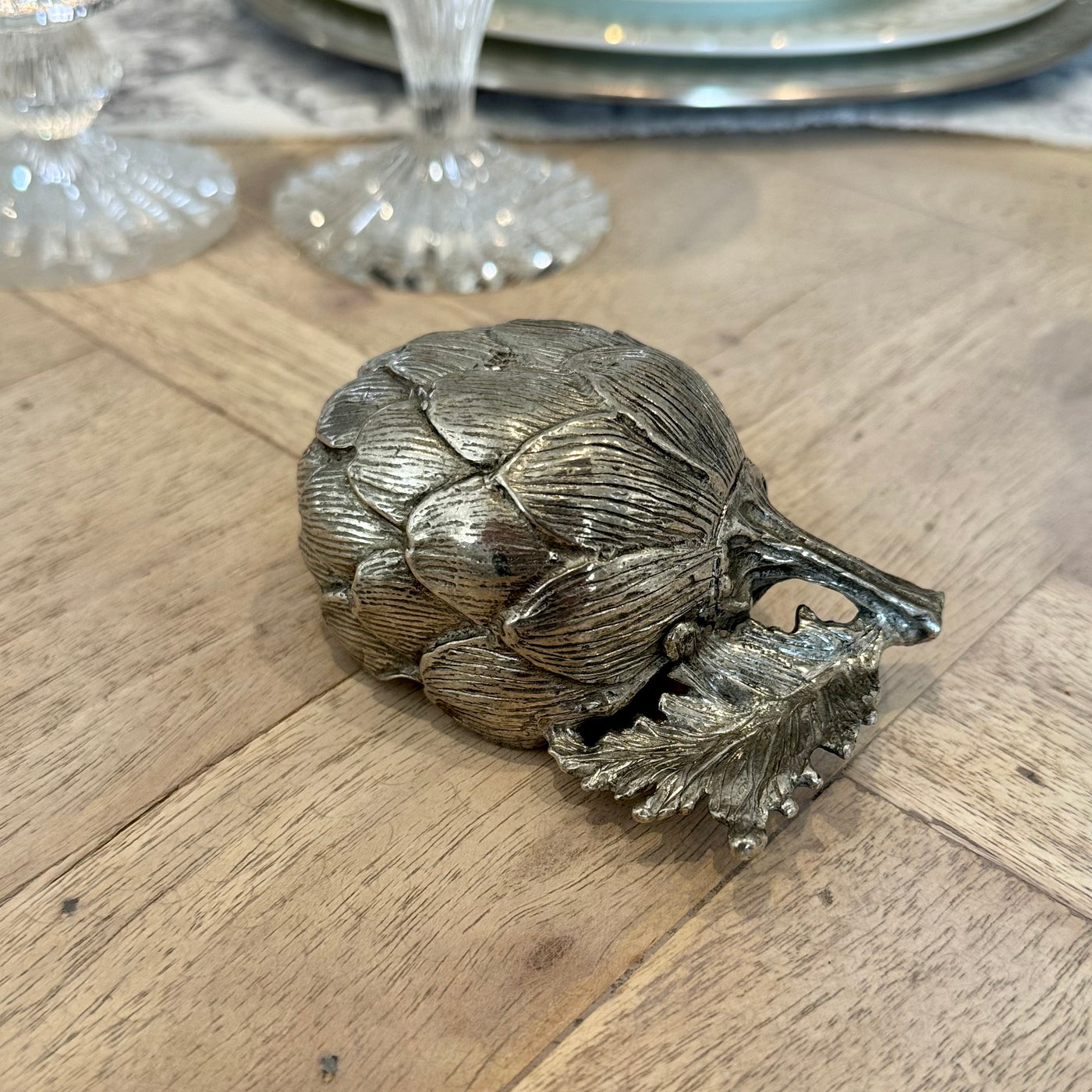 Side view of the pewter artichoke salt cellar showing the textured leaves and branch handle