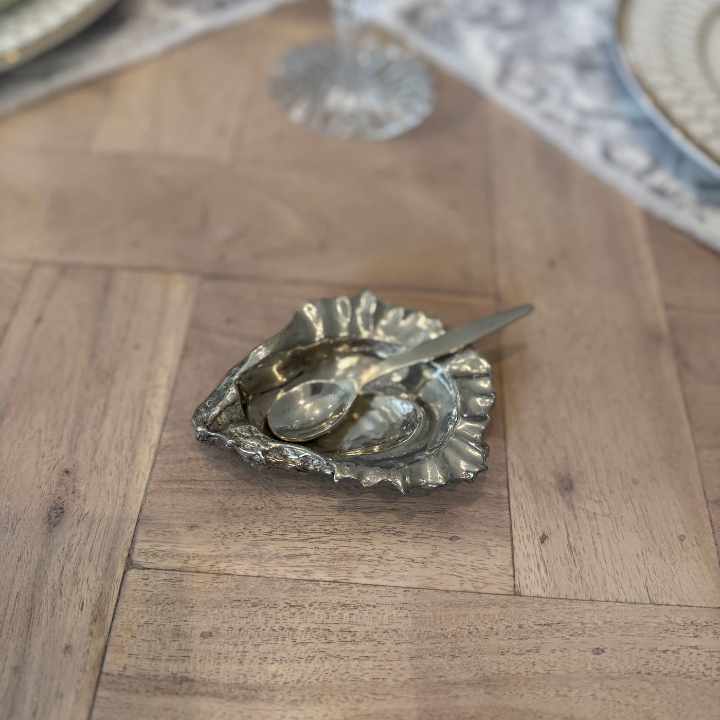 Overhead view of the oyster shell salt pot with the spoon resting inside