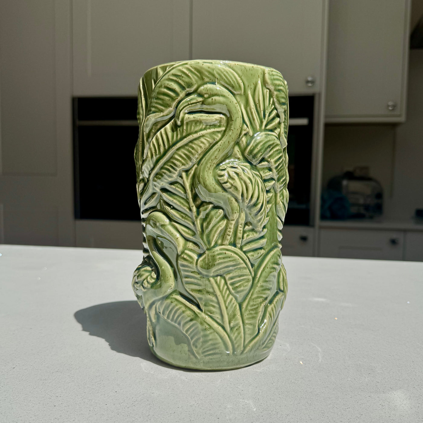 Ceramic flamingo vase with raised botanical foliage