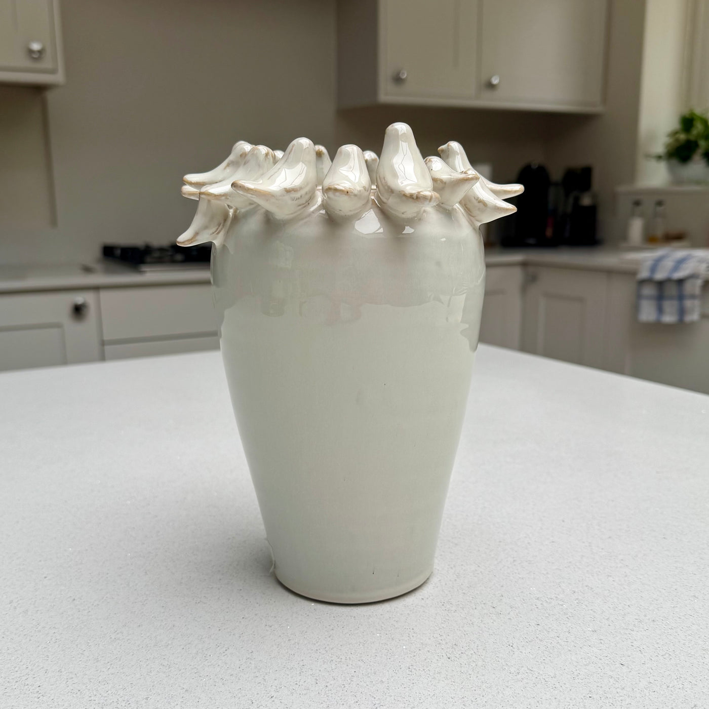 Natural beige ceramic vase with sculpted birds