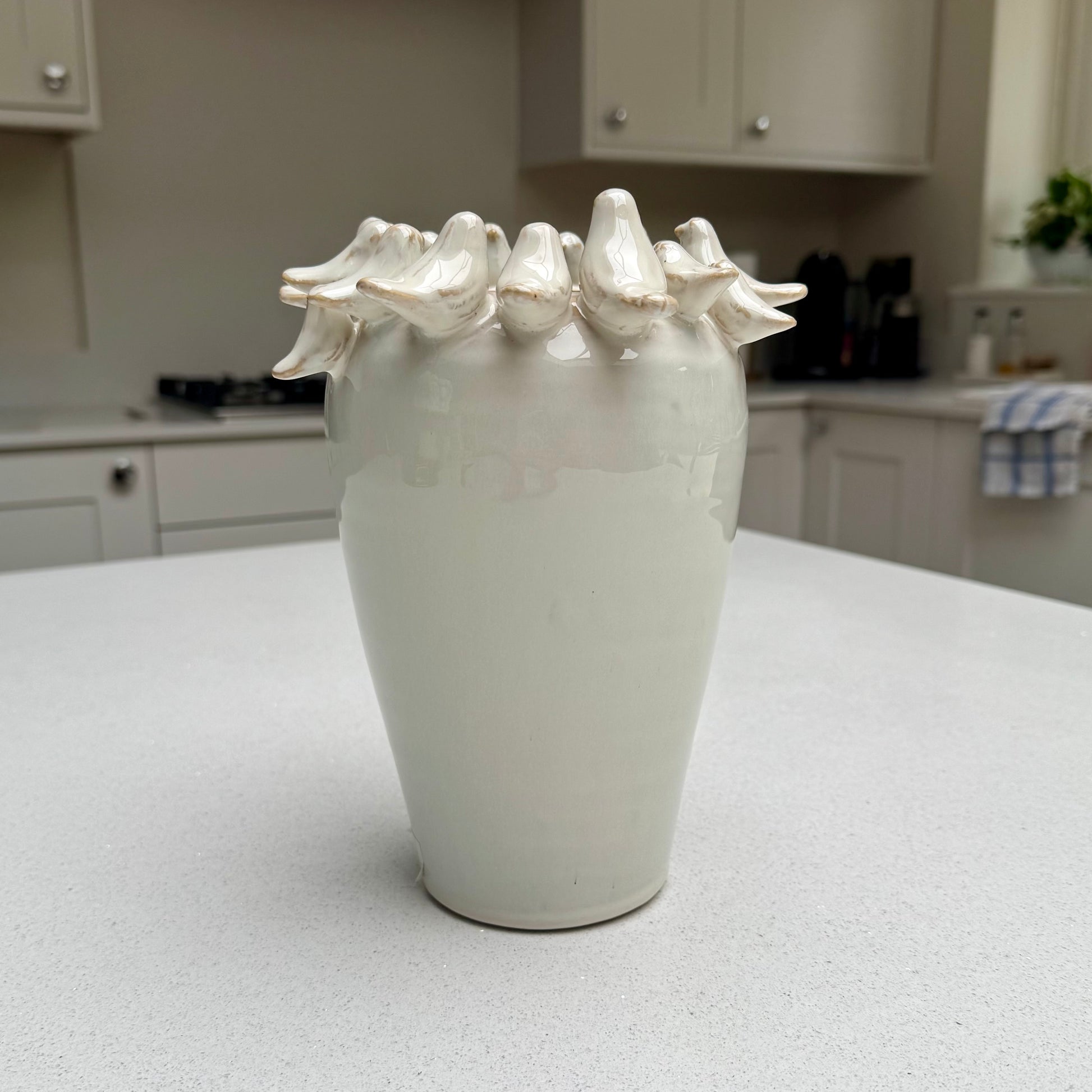 Natural beige ceramic vase with sculpted birds
