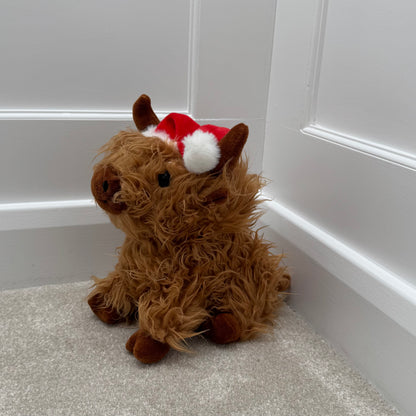 Sitting Highland Cow Doorstop with Santa Hat – 23cm