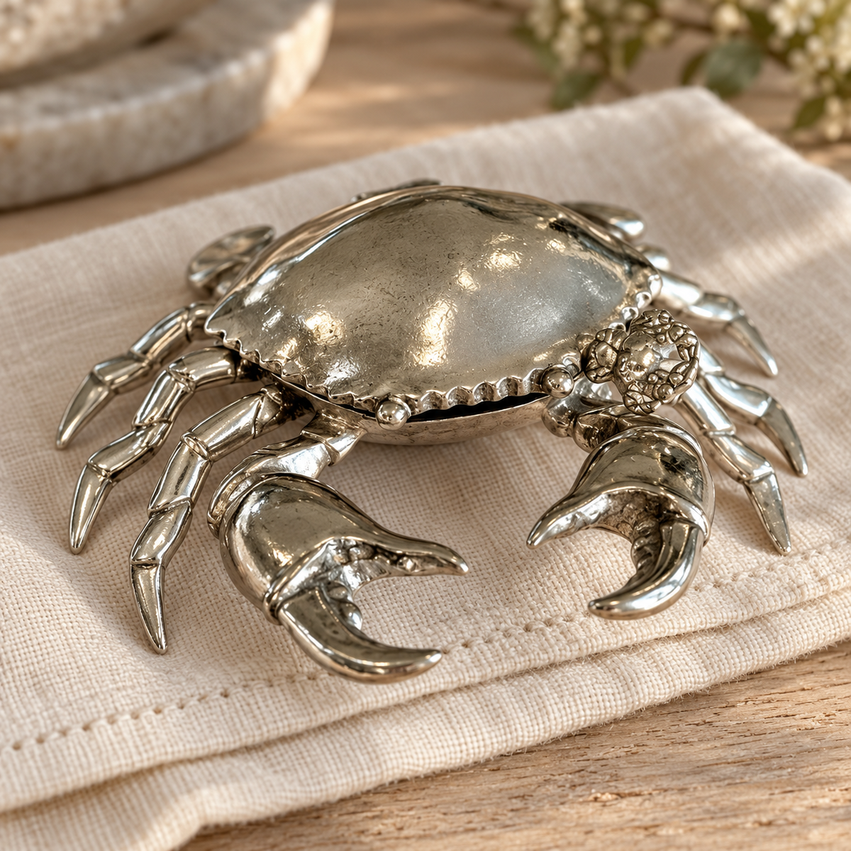 Close-up of the polished shell, detailed legs and claws of the pewter crab salt pot