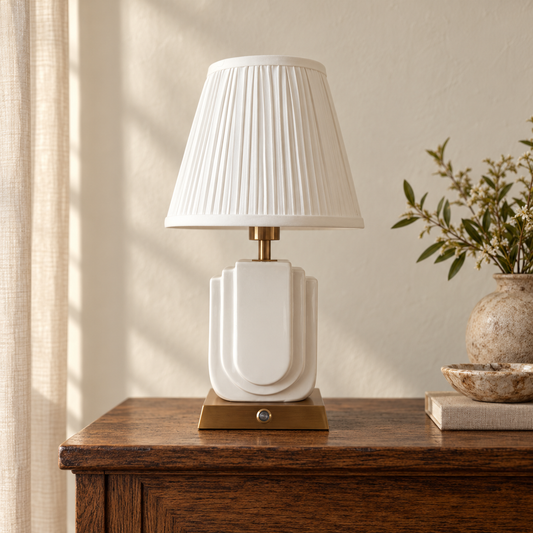 Belgravia white ceramic and brushed gold lamp with pleated shade on an oak console