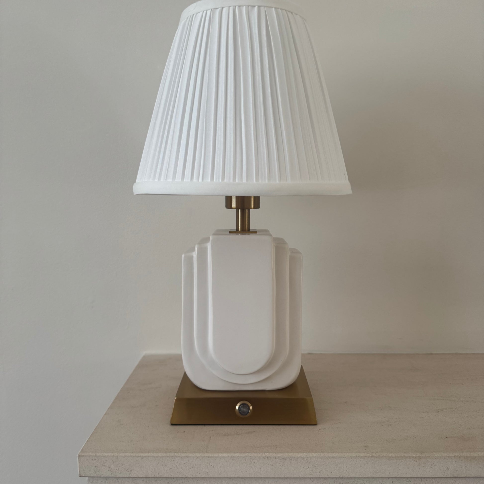 Belgravia handmade ceramic rechargeable table lamp in white with brushed gold base and white pleated shade