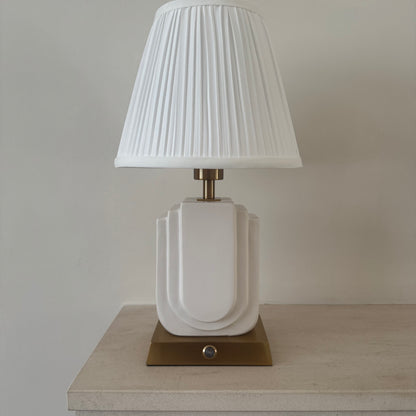 Belgravia handmade ceramic rechargeable table lamp in white with brushed gold base and white pleated shade