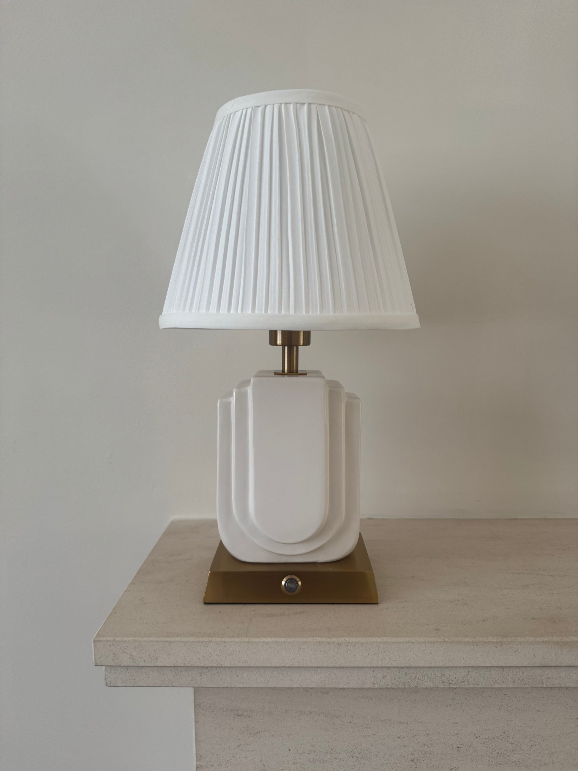 Belgravia handmade ceramic rechargeable table lamp in white with brushed gold base and white pleated shade