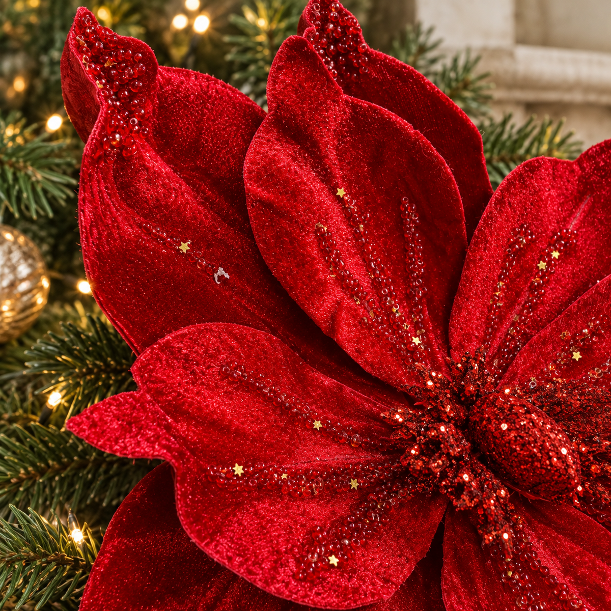 Detail of crimson velvet petals decorated with sparkling beads, glitter and gold star sequins.