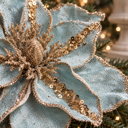 Macro detail of soft blue velvet-finish petals with gold sequins and glittered edges.