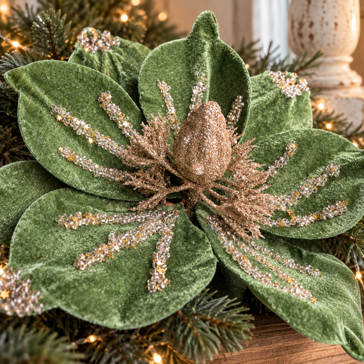 Detail of the champagne-gold glittered bud and layered jade green velvet petals of the poinsettia.